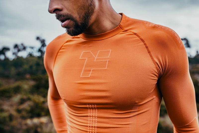 Man wearing an orange long-sleeved seamless shirt from Fyke