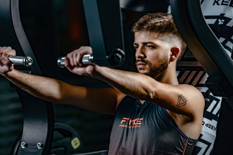 Man in a gym shirt doing arm workouts